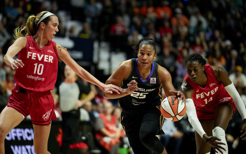 UNCASVILLE, CONNECTICUT - SEPTEMBER 25: Alyssa Thomas #25 of the Connecticut Sun drives against Lexie Hull #10 and Temi Fagbenle #14 of the Indiana Fever during the first quarter of Game Two of the 2024 WNBA Playoffs first round at Mohegan Sun Arena on September 25, 2024 in Uncasville, Connecticut. (Photo by Joe Buglewicz/Getty Images)