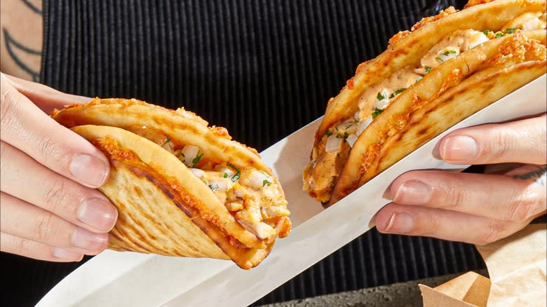 Person holding Taco Bell Cheesy Street Chalupas