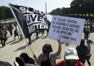 FILE - In this Aug. 28, 2020, file photo, demonstrators gather near the Lincoln Memorial as final preparations are made for the March on Washington, in Washington, on the 57th anniversary of the Rev. Martin Luther King Jr.'s "I Have A Dream" speech. Several years since its founding, BLM has evolved well beyond the initial aspirations of its early supporters. Now, its influence faces a test, as voters in the Tuesday, Nov. 3 general election choose or reject candidates who endorsed or denounced the BLM movement amid a national reckoning on race (Olivier Douliery/Pool Photo via AP, File)