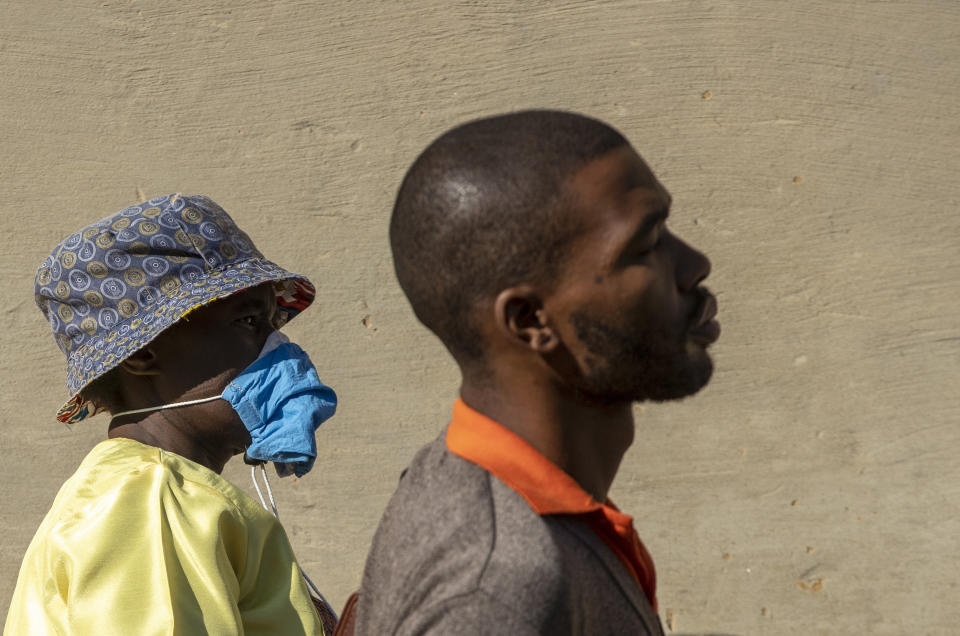 A woman wearing a homemade mask walks on the streets of Soweto, South Africa, Thursday, April 23, 2020, as the country remains in lockdown for a fourth week in a bid to combat the spread of the coronavirus. Africa has registered a 43% jump in reported COVID-19 cases in the last week, highlighting a warning from the World Health Organization that the continent of 1.3 billion could become the next epicentre of the global outbreak. (AP Photo/Themba Hadebe)