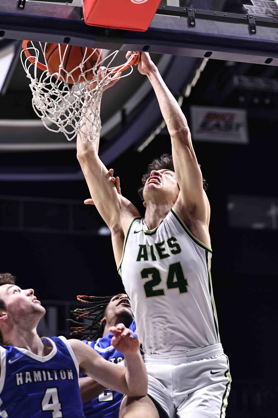 Sycamore center Raleigh Burgess (24) dunks over Hamilton's Peyton Davis (4) during their district final Sunday, March 10, 2024.