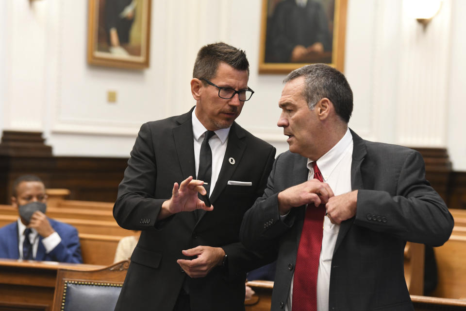 Assistant District Attorney Thomas Binger, left, and defense attorney Mark Richards talk before a motion hearing of Kyle Rittenhouse, Tuesday, Oct. 5, 2021, in Kenosha, Wis. Kyle Rittenhouse is accused of shooting three people during a protest against police brutality in Wisconsin last year. (Mark Hertzberg/Pool Photo via AP)