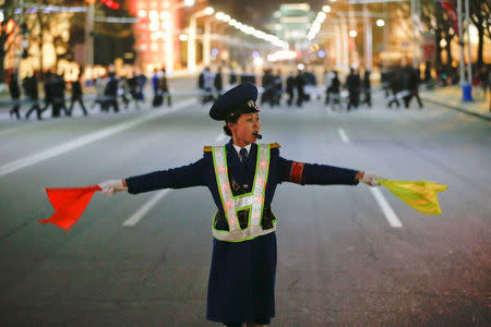 A policewoman controls the traffic as people gather near the main Kim Il Sung square in central Pyongyang, North Korea April 11, 2017. REUTERS/Damir Sagolj