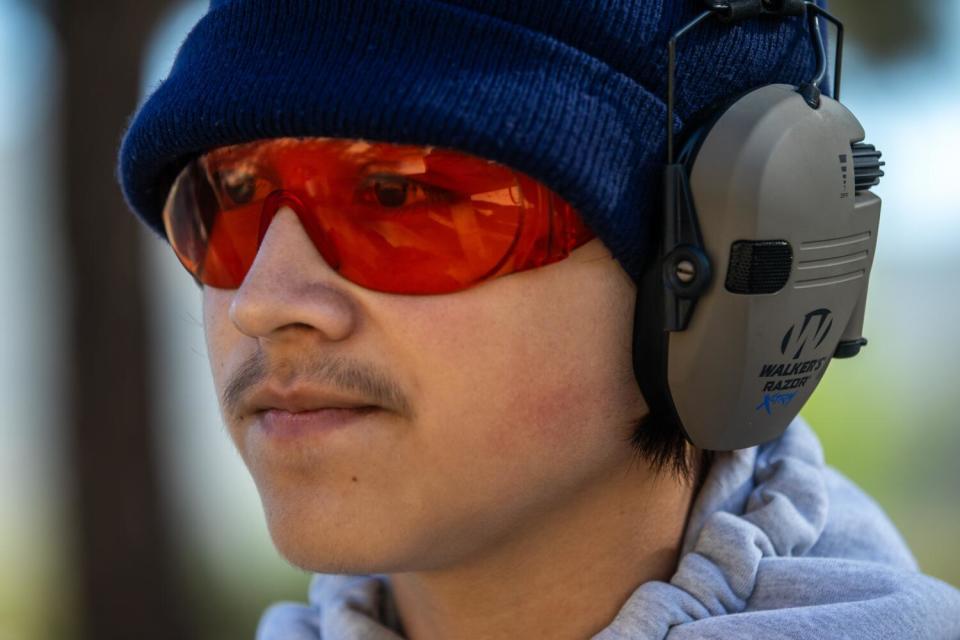 A close-up of Daniel Villalpando, 16, wearing a beanie, ear muffs and shooting glasses