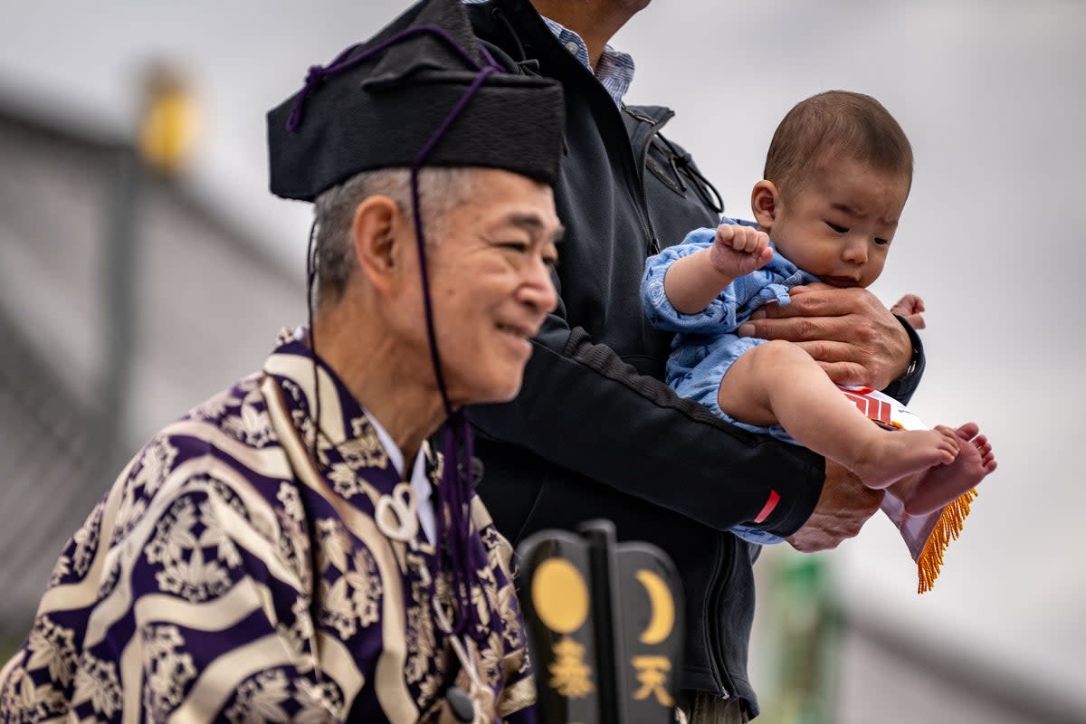 A parent holds his child for a photo call at the Sensoji temple in Tokyo (AFP via Getty Images/ Representative image)