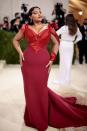 <p>Model Paloma Elesser was the picture of old Hollywood glamour in a deep red satin gown by American designer Zac Posen, which featured a dramatic feathered train.</p>