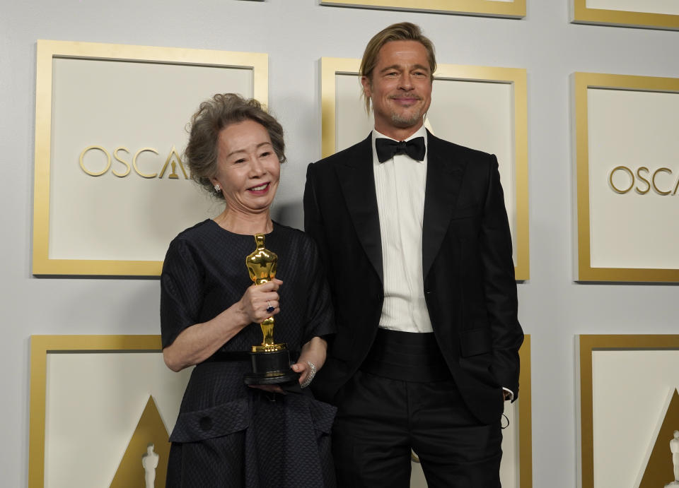 Brad Pitt, right, poses with Yuh-Jung Youn, winner of the award for best actress in a supporting role for "Minari," in the press room at the Oscars on Sunday, April 25, 2021, at Union Station in Los Angeles. (AP Photo/Chris Pizzello, Pool)