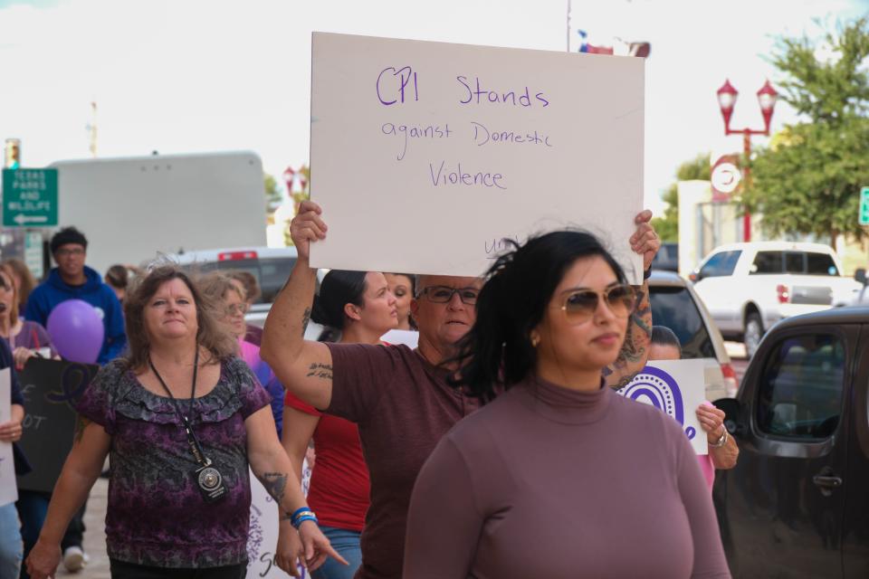 More than 100 community members join the Community Walk Against Domestic Violence on Monday afternoon in downtown Amarillo.