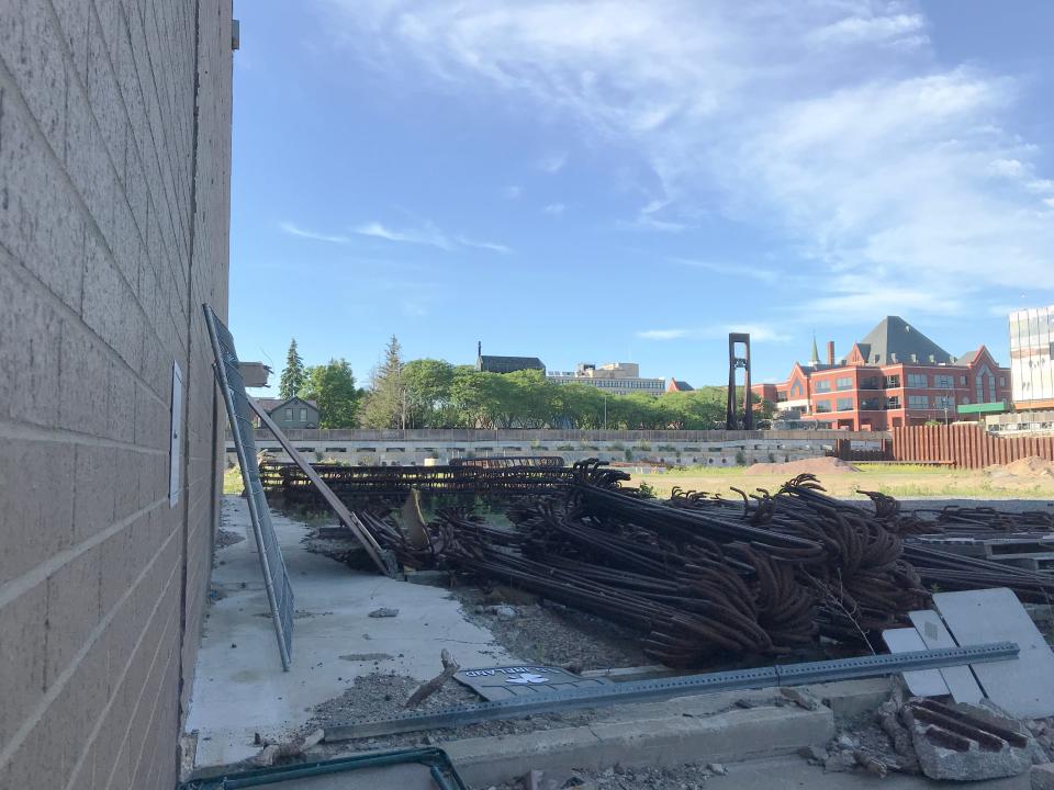 The Zampieri State Office Building in Burlington stands beyond the site of the former Burlington Town Center shopping mall, viewed from the southwest on June 9, 2021.
Construction materials for a proposed redevelopment of the site lie in the foreground; the eight-story building at 100 Bank Street stands to the left.