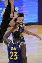 Golden State Warriors' Stephen Curry, top, celebrates a basket by Draymond Green during the second half of an NBA basketball game against the Los Angeles Lakers, Monday, Jan. 18, 2021, in Los Angeles. The Warriors won 115-113. (AP Photo/Jae C. Hong)