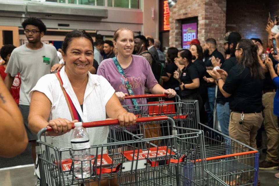 Shoppers walk into the store during the grand opening of HEB on Wednesday, June 26 in Mansfield. Shoppers were greeted by staff by cheering them in and high fives.