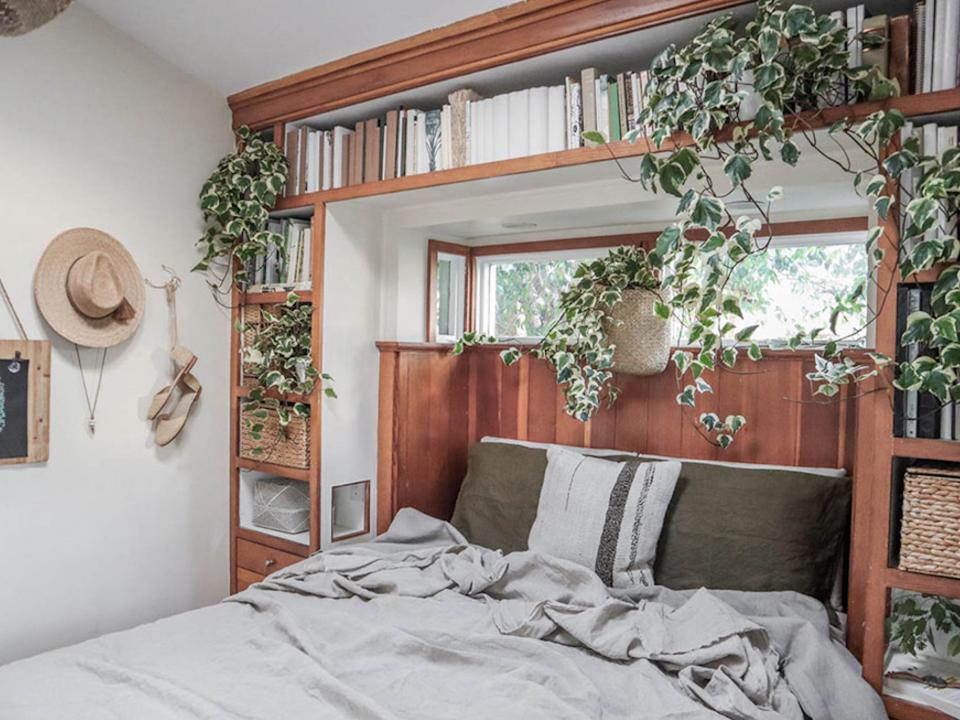 The bedroom with shelving inside the The Tiny Canal Cottage by Whitney Leigh Morris