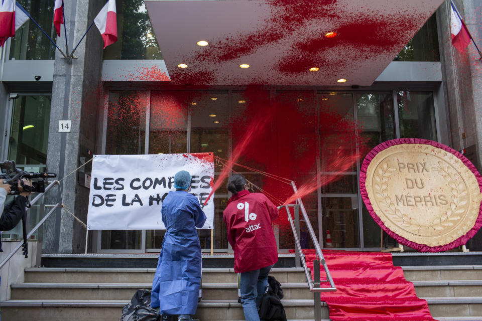 French activists of Attac stage a flash protest outside the French Health Ministry in support of medical workers, in Paris, France, Saturday, June 20, 2020. French hospital workers and others are protesting to demand better pay and more investment in France's public hospital system, which is considered among the world's best but struggled to handle a flux of virus patients after years of cost cuts. (AP Photo/Rafael Yaghobzadeh)