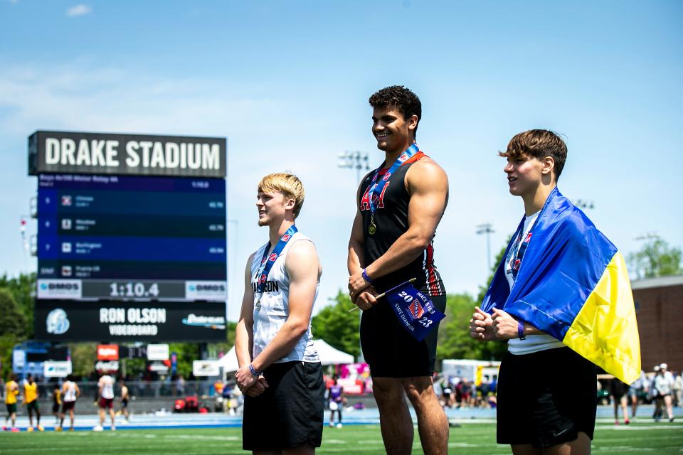 Akron-Westfield's Ian Blowe, center, stands atop the awards stand for the Class 1A boys discus throw after winning during the high school state track and field championships, Friday, May 19, 2023, at Drake Stadium in Des Moines, Iowa. Second place finisher West Harrison's Koleson Evans, left, and third place finisher WACO's Oleh Shtefanchuk as he holds holds the flag of Ukraine. Blowe turned in the best 2024 state-qualifying discus and shot put tosses in Class 1A during the 1A qualifying meet at Westwood High School in Sloan.