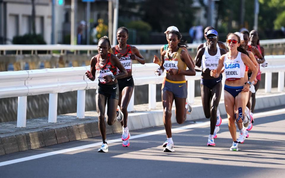 Tokyo 2020 Olympics - Athletics - Women's Marathon - Sapporo Odori Park, Sapporo, Japan - August 7, 2021. Peres Jepchirchir of Kenya, Melat Yisak Kejeta of Germany and Molly Seidel of the United States in action. - REUTERS/Kim Hong-Ji