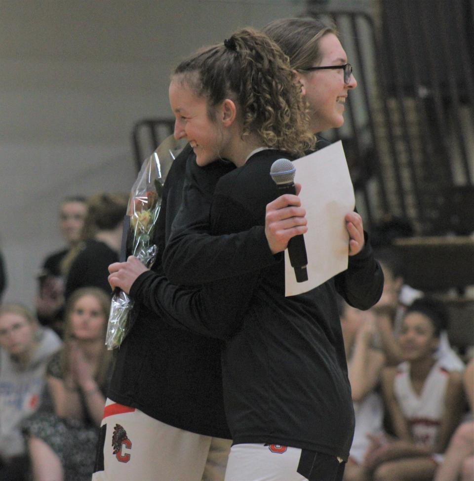 Cheboygan senior Emily Clark (right) gets a hug from freshman teammate Cloee Rupp prior to a home game against Kalkaska on Thursday, Feb. 29. On senior night, Clark helped lift the Chiefs to a win in the final home game of her career.