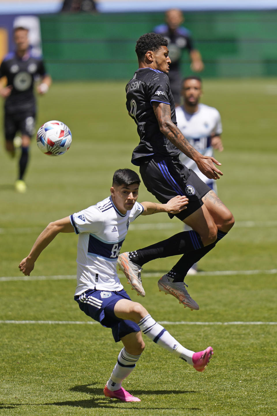 Vancouver Whitecaps defender Cristian Gutierrez, left, and CF Montréal forward Bjorn Johnsen (9) battle for the ball in the first half during an MLS soccer game Saturday, May 8, 2021, in Sandy, Utah. (AP Photo/Rick Bowmer)