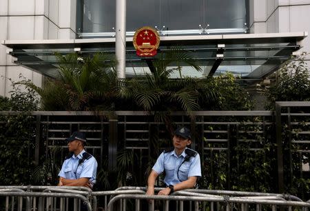 Policemen are seen on duty outside China's Liaison Office during a protest on the disappearance of five booksellers in Hong Kong, China January 4, 2016. REUTERS/Bobby Yip/File Photo