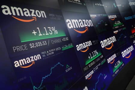 FILE PHOTO: The Amazon.com logo and stock price information is seen on screens at the Nasdaq Market Site in New York City