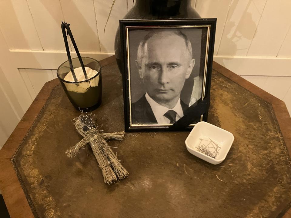 A doll, a bowl of pins and a framed photo of Russian President Vladimir Putin are displayed for customers’ use at the Simona pizzeria in central Kyiv on Nov. 17, 2022. Plenty of customers clearly felt the cathartic need to vent their anger against the Russia leader: the doll was pin-stuck from head nearly to toe. The hard realities of Ukraine’s capital are that a once comfortably livable city of 3 million people is now becoming a tough place to live. But Kyiv has hope, resilience and defiance in abundance. And perhaps more so now than at any time since Russia invaded Ukraine nine months ago. (AP Photo/John Leicester)