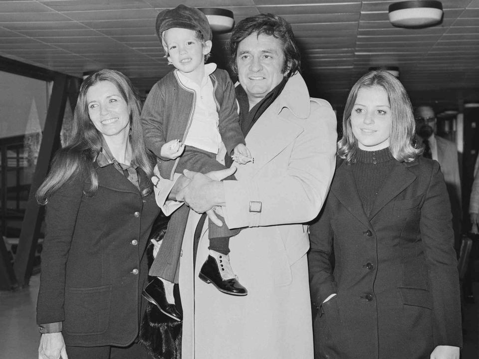 <p>R. Brigden/Daily Express/Hulton Archive/Getty</p> Johnny Cash, June Carter Cash, John Carter Cash, and Cindy Cash at Heathrow airport in London on September 25, 1972.