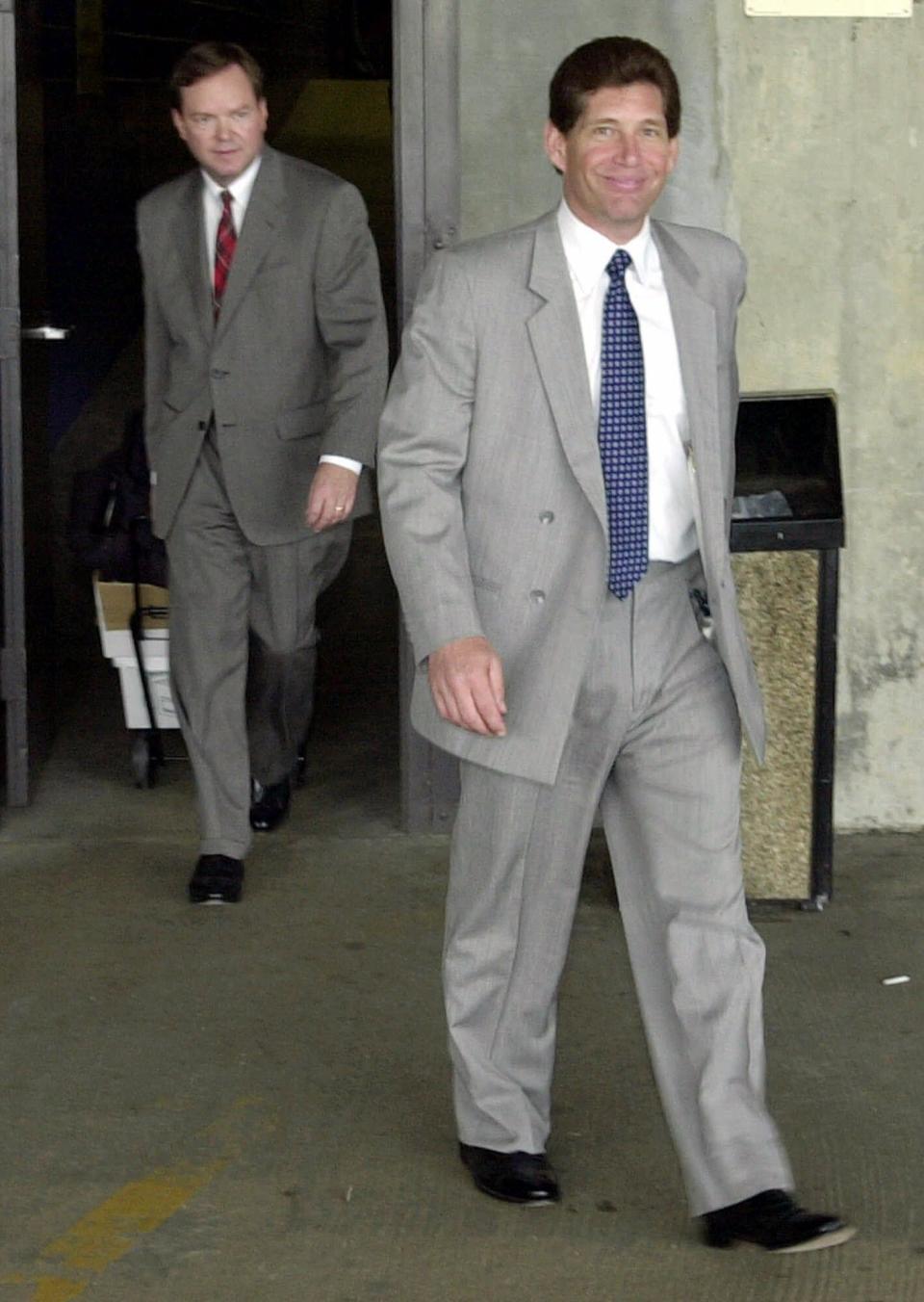 Michael DiLeonardo, right, accused of being a member of the Gambino crime family, right, followed by his attorney Craig Gillen, left, leave the federal building in Atlanta, Wednesday, Aug. 1, 2001. With no explanation from defense attorneys and prosecutors, testimony in the Gold Club trial was abruptly canceled Wednesday, and the proceedings were put on hold. (AP Photo/Gregory Smith)