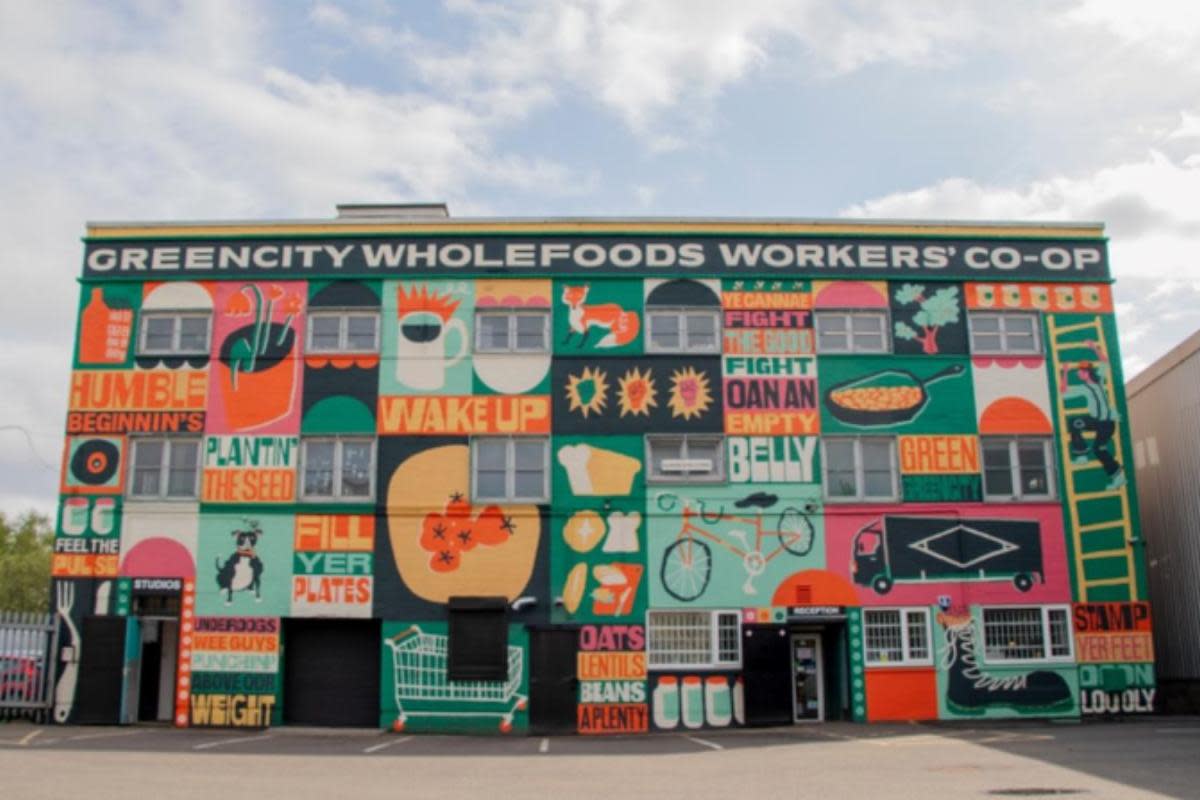 The vibrant artwork, now adorning the front of Greencity Wholefoods' building, represents the cooperative's members, a total of more than 50 <i>(Image: Greencity Wholefoods)</i>