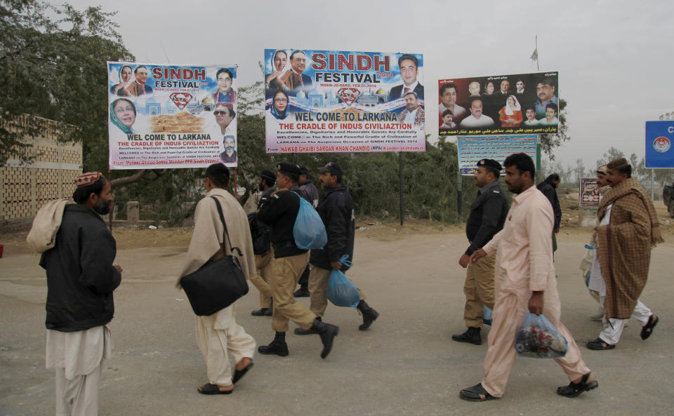 Pakistani police officers arrive to take up security duty for a grand cultural festival at the ruins of Mohenjodaro, listed on UNESCO's list of world heritage sites, near Larkana, some 400 kilometers ( 248 miles) from north of the Pakistani port city Karachi, Saturday, Feb. 1, 2014. The event at Mohenjodaro, whose unbaked brick ruins date to the 3rd millennium BC, has however drawn criticism from some archaeologists who say it poses a risk to the monuments. Bilawal Bhutto Zardari, the son of assassinated Pakistani Prime Minister Benazir Bhutto, organized the Festival aimed at promoting peace in this Islamic nation, where militant violence has killed over 40,000 people in recent years, organizers said. (AP Photo/Shakil Adil)