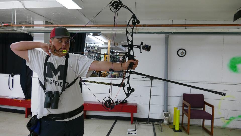 Métis competitor Ethan Hall practises archery at an indoor shooting range in Manitoba days before heading out to the Native American Indigenous Games in Halifax. (Walther Bernal/CBC  - image credit)