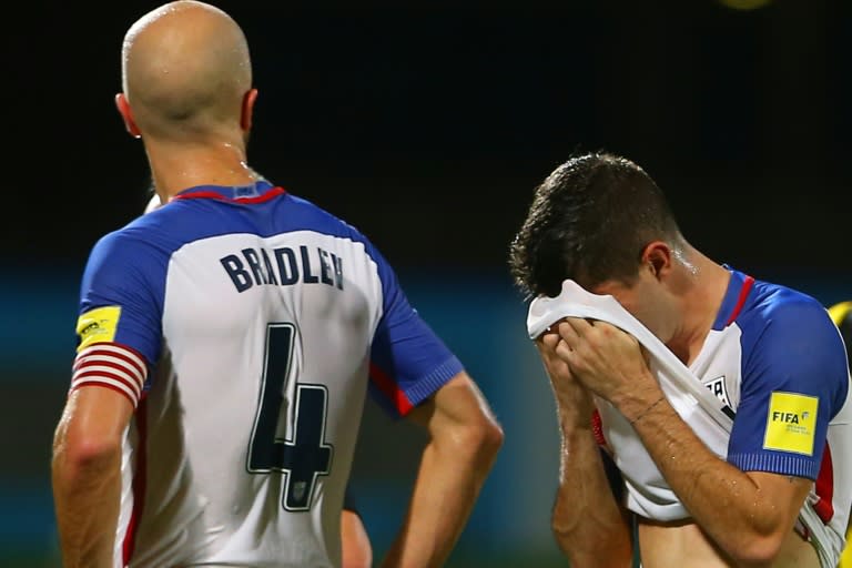 Michael Bradley (L) and Christian Pulisic of the US react to loss against Trinidad and Tobago after their FIFA 2018 World Cup qualifier match, at the Ato Boldon Stadium in Couva, Trinidad And Tobago, on October 10, 2017