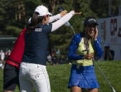 Paula Reto, from South Africa, laughs as she is sprayed with champagne following her first LPGA win at the CP Women's Open golf tournament, Sunday, Aug. 28, 2022, in Ottawa, Ontario. (Adrian Wyld/The Canadian Press via AP)