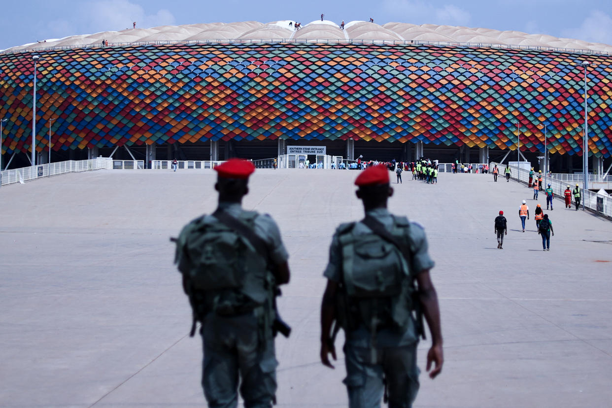 Cameroonian soldiers patrol the entrance of the Olembe Stadium prior to the start of AFCON on Jan. 7. A crush of fans at the African Cup of Nations left six dead and at least 40 injured.