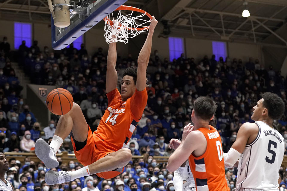 FILE - Syracuse center Jesse Edwards (14) dunks as forward Jimmy Boeheim (0) and Duke forward Paolo Banchero (5) watch during the first half of an NCAA college basketball game in Durham, N.C., Saturday, Jan. 22, 2022. Edwards is one of two starters back for another season. (AP Photo/Gerry Broome, File)