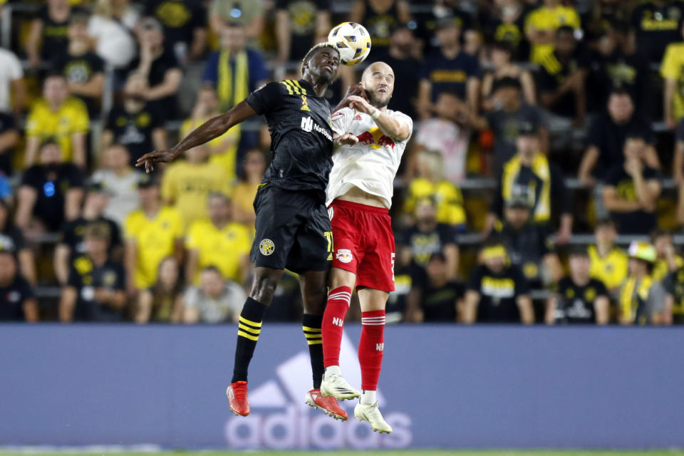 Columbus Crew forward Gyasi Zardes, left, heads the ball in front of New York Red Bulls defender Andrew Gutman during an MLS soccer match in Columbus, Ohio, Tuesday, Sept. 14, 2021. The Crew won 2-1. (AP Photo/Paul Vernon)