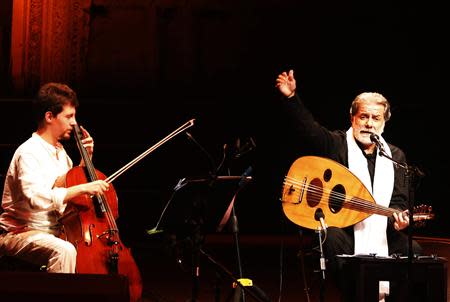 Lebanese composer and singer Marcel Khalife performs with cello player Sari Khalife during the Baalbek festival, which was held in La Magnanerie, a 19th century silk factory, in Beirut August 24, 2013. REUTERS/Jamal Saidi