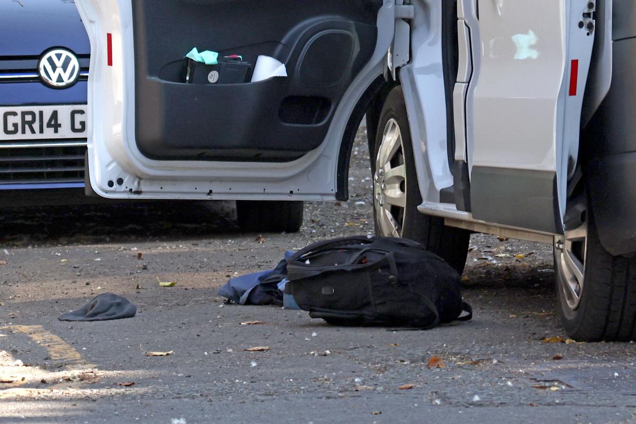 A rucksack and other items are pictured on the road, next to the open door of a white van, inside a police cordon on Bentinck Road in Nottingham (AFP/Getty)