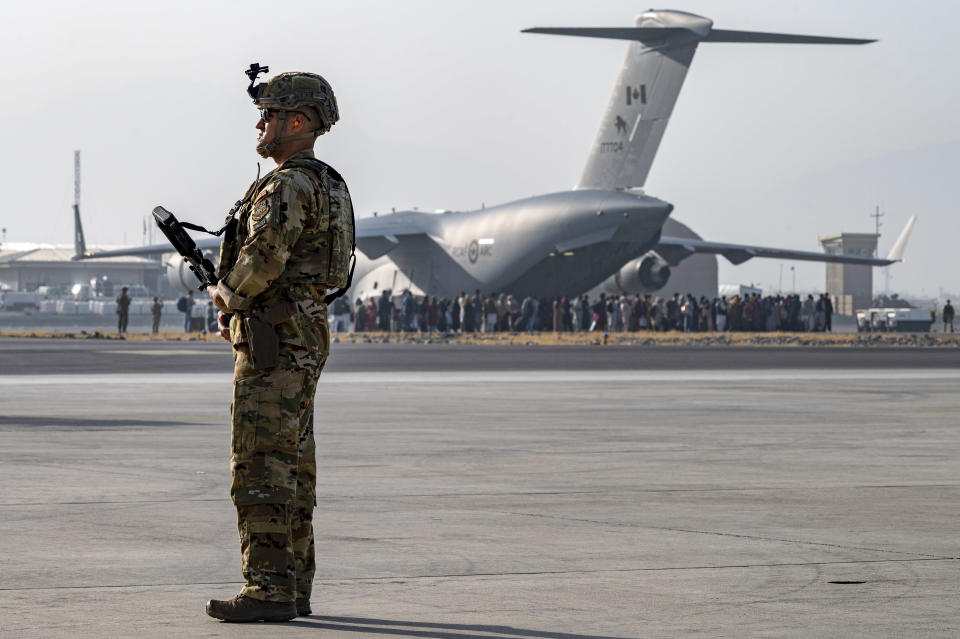 In this image provided by the U.S. Air Force, a U.S. Air Force security forces Raven maintains a security cordon around a U.S. Air Force C-17 Globemaster III aircraft at Hamid Karzai International Airport in Kabul on Friday. (Senior Airman Taylor Crul/U.S. Air Force via AP)