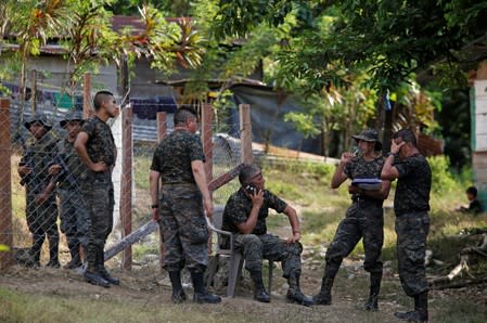 Soldiers receive instructions during a temporary state of siege, approved by the Guatemalan Congress following the death of several soldiers last week, in the community of Semuy II, Izabal province