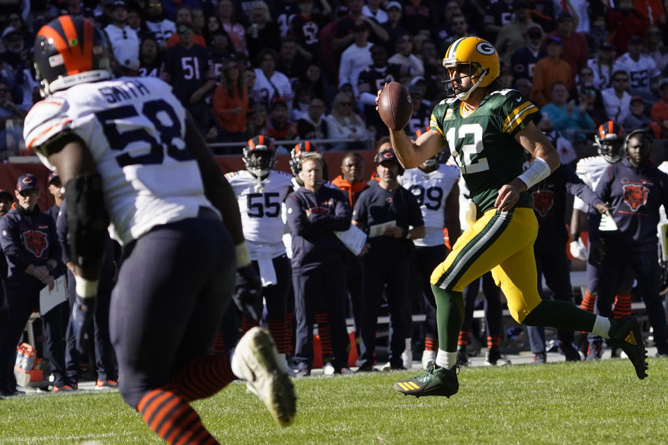 Green Bay Packers quarterback Aaron Rodgers pulls the ball down and runs for a touchdown during the second half of an NFL football game against the Chicago Bears Sunday, Oct. 17, 2021, in Chicago. (AP Photo/David Banks)