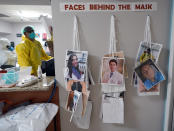 Photographs of staff working at the Coronavirus Unit at United Memorial Medical Center hang on the wall Monday, July 6, 2020, in Houston. The photographs help patients know who is behind the mask. (AP Photo/David J. Phillip)