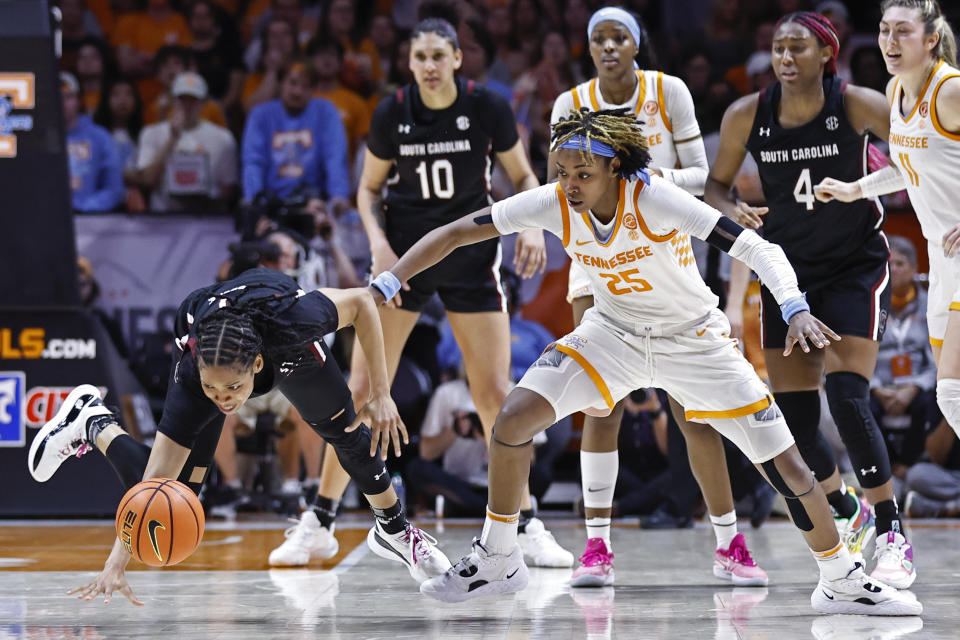 South Carolina guard Zia Cooke, left, falls to the floor as she battles for the ball with Tennessee guard Jordan Horston (25) during the second half of an NCAA college basketball game, Thursday, Feb. 23, 2023, in Knoxville, Tenn. (AP Photo/Wade Payne)