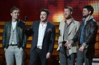 Mumford & Sons, winners for Best Album of the Year, react on stage at the Staples Center during the 55th Grammy Awards in Los Angeles, California, February 10, 2013