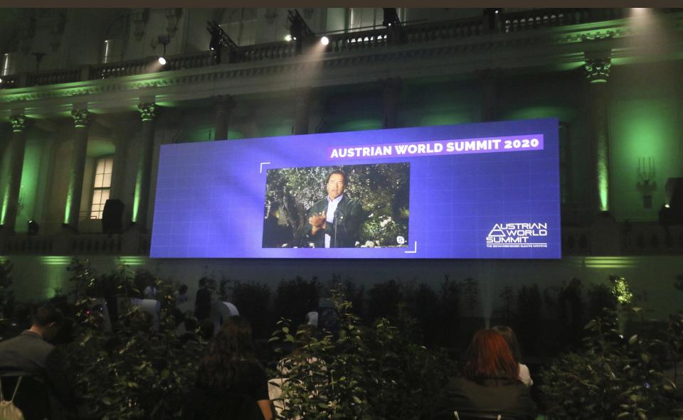 Former California Gov. Arnold Schwarzenegger is seen on a giant video screen during his online broadcasted speech as part of the 'Austrian World Summit' at the Spanish Riding School in Vienna, Austria, Thursday, Sept. 17, 2020. (AP Photo/Ronald Zak)