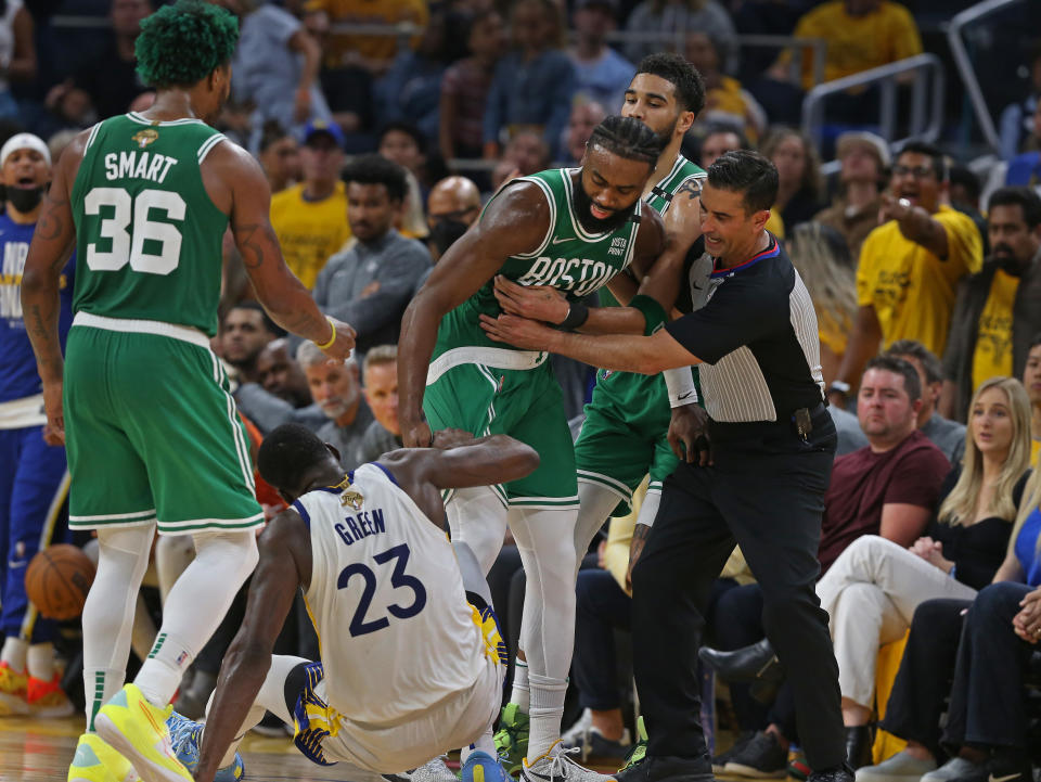 The Golden State Warriors' Draymond Green and the Boston Celtics Jaylen Brown hit the floor and as they both got up, Green held Brown's shorts, which touched off some verbal reactions and a separation during Game 2 of the 2022 NBA Finals at the Chase Center in San Francisco on June 5, 2022. (Jim Davis/The Boston Globe via Getty Images)