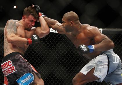 Frank Mir (L) absorbs a punch from Alistair Overeem at UFC 169. (AP)