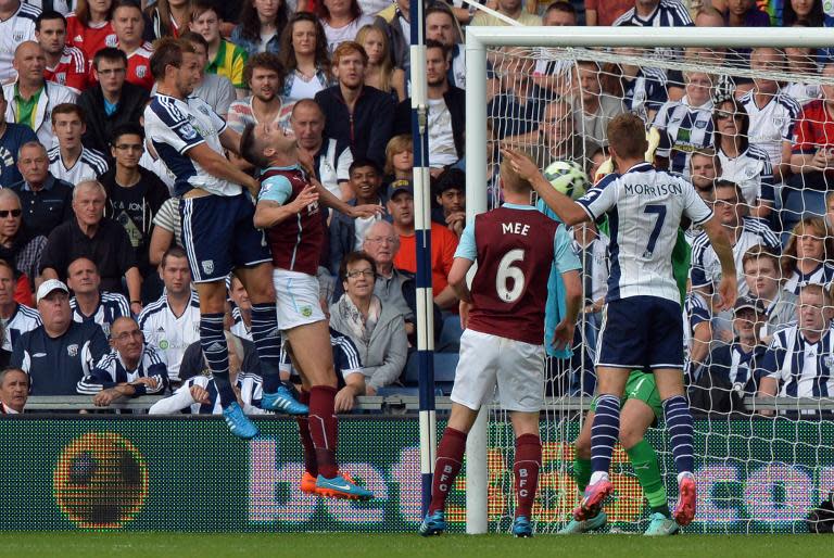 West Bromwich's Craig Dawson (L) scores during an English Premier League match against Burnley at the Hawthorns on September 28, 2014