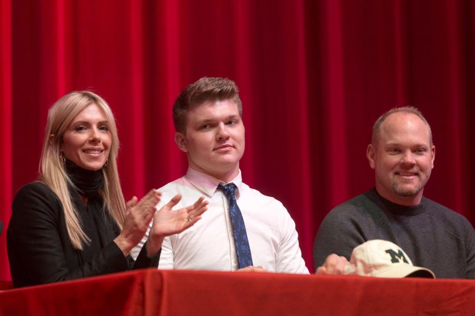 The Hutchinson family from left, Melissa Hutchinson, Aidan Hutchinson, and Chris Hutchinson wait for Dearborn Divine Child High School senior, Aidan to sign with Michigan to play football on Wednesday, Dec. 20, 2017, in Dearborn.