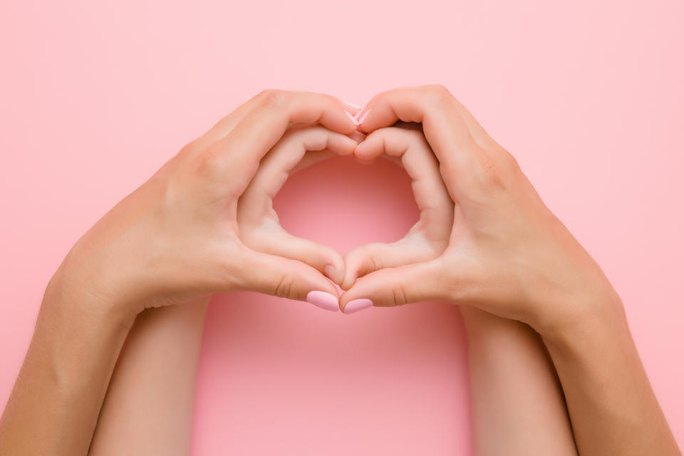 Heart shape created from little girl's hands and her mother's hands