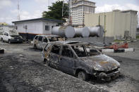 Burnt vehicles are seen near the Lekki toll gate, in Lagos, Friday, Oct. 23, 2020. Resentment lingered with the smell of charred tires Friday as Nigeria's streets were relatively calm after days of protests over police abuses, while authorities gave little acknowledgement to reports of the military killing at least 12 peaceful demonstrators earlier this week. (AP Photo/Sunday Alamba)