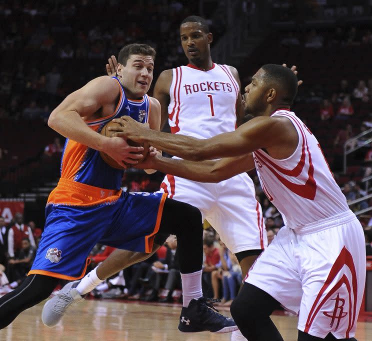 The Shanghai Sharks’ Jimmer Fredette, left, drives against the Houston Rockets’ Eric Gordon during an exhibition game on Oct. 2, 2016, in Houston. (AP)